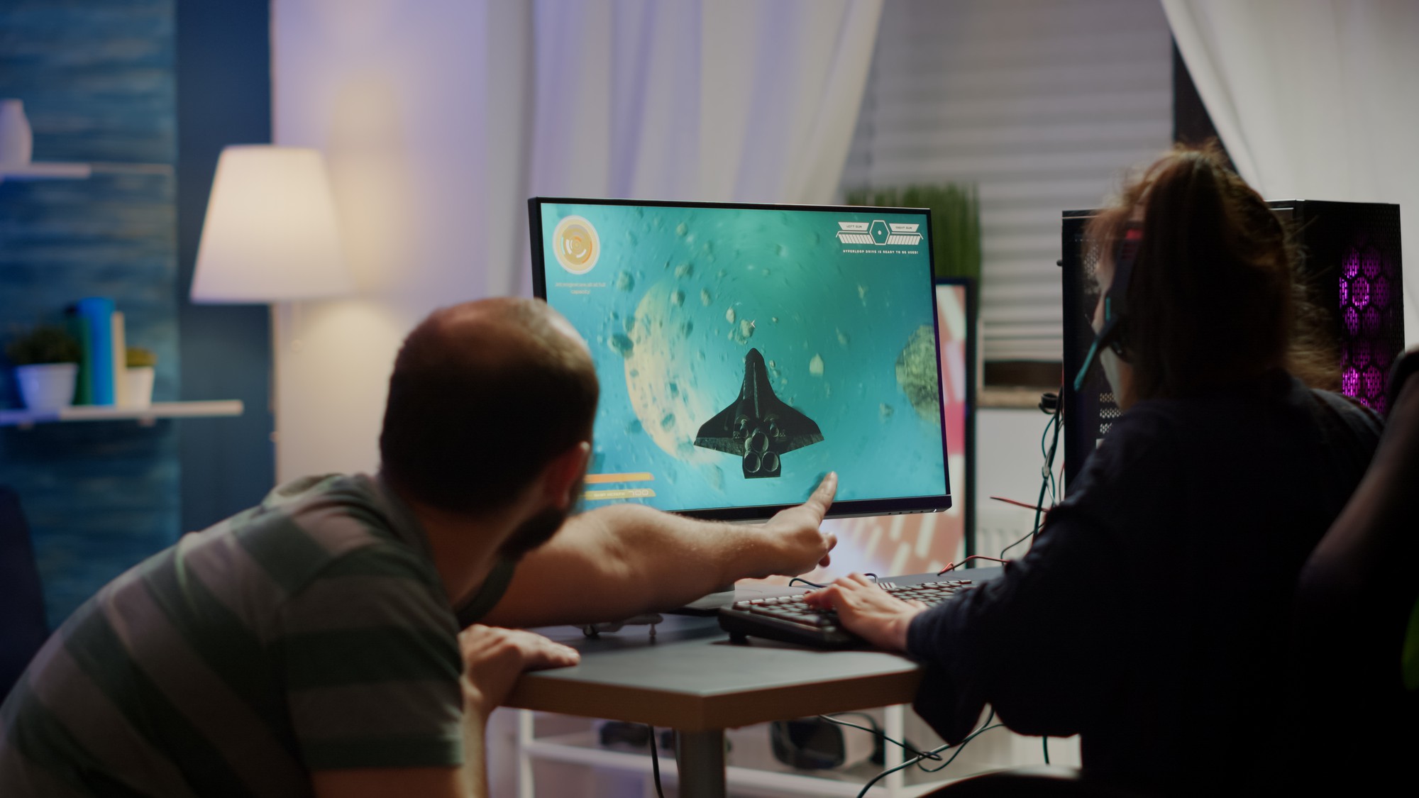 Team reviewing game design on monitor