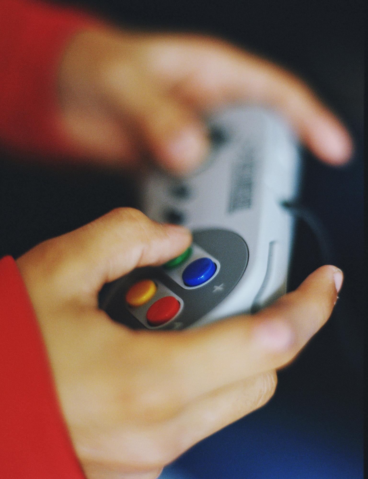Close-up of game controller and hands